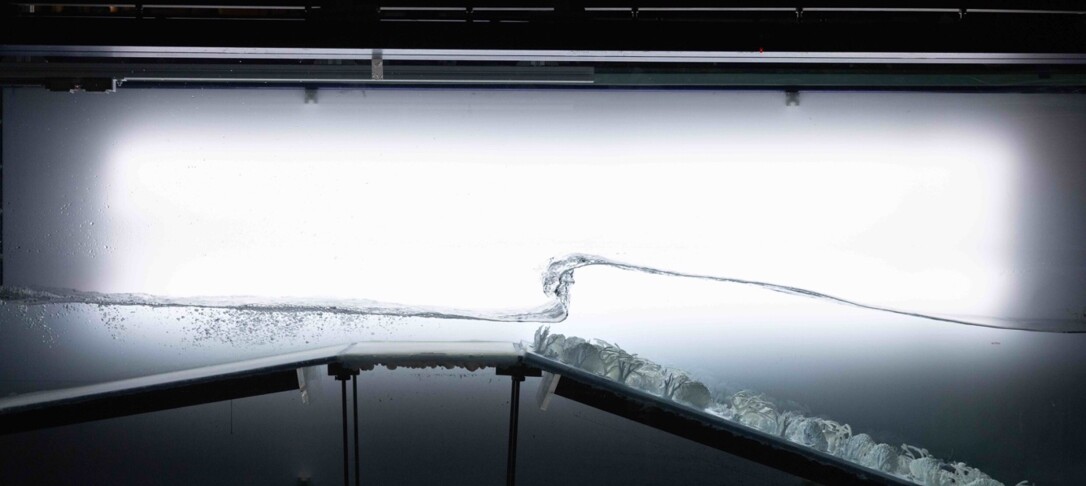 Image underwater of wave hitting bedrock in a laboratory setting